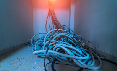 Pile of cables on floor in new building. Electricity installation and interior renovation. Closeup.