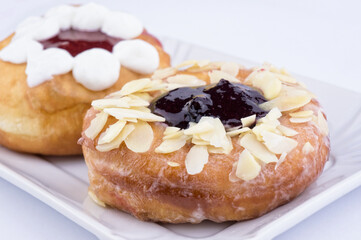 Donuts stuffed with fresh cream and jam closeup