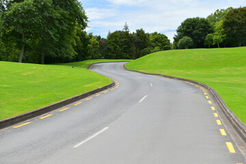 Fototapeta premium View of asphalt road winding through green hills