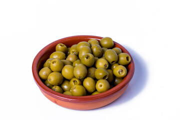 Olives stuffed with anchovies in a ceramic bowl and white background