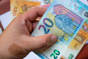 Euro currency close up in the hands of a rich man