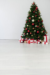 beautiful Christmas tree with gifts decor new year and terrier white room