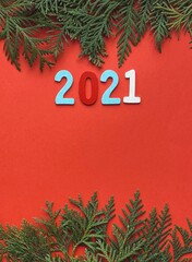 2021 wooden date on red Christmas background. 