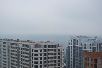 roofs of new houses with fog in the background