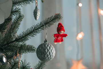 Red knitted doll on a Christmas tree