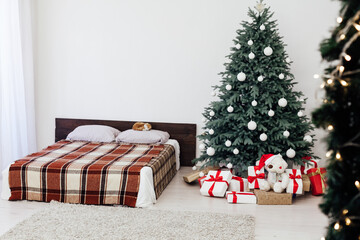 bedroom with bed decor new year and beautiful Christmas tree with gifts