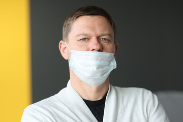 Man with an incorrectly worn protective medical mask.