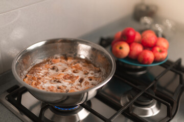 The process of preparing jam from red apples