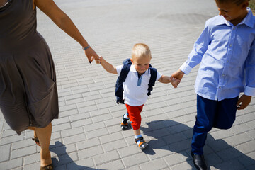 little happy child walks and holds hands