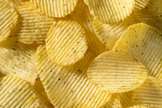 potato chips with fluted texture close up as background