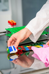 Female doctor's hands prepare tools for blood sampling in the lab
