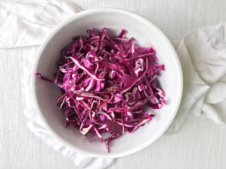 Red cabbage salad preparation. A bowl full with shredded cabbage.
