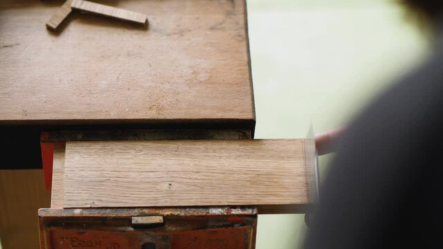 a carpenter saws a groove in a wooden oak blank with a Japanese hand saw.handmade carpentry. the sound of carpentry tools