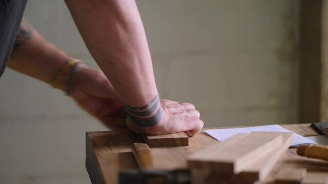 the carpenter makes the markings on the oak blank using marking gauge. handmade carpentry. the sound of carpentry tools