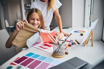 Merry young stylist working in her studio