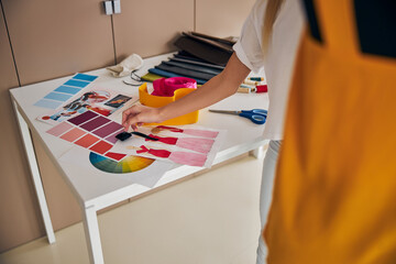 Dressmaker pulling a pin from the pincushion