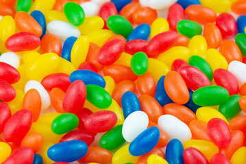 Multicolor Jelly Beans Candy Background. Bright Tasty Colourful Texture Of Blue, Green, Yellow, Red, Orange and White Sweets Close Up. Unhealthy Food