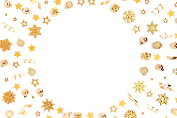 Round frame made of gold Christmas toys pattern on a white background. Festive concept with place for your design.
