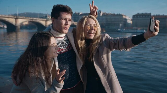 Three friends taking selfe in Prague. Travel, friendship, youth, millenial, blogger, fame social media concept. Filmed on REd 4k, 10 bit color