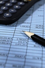 pen and calculator on financial newspaper