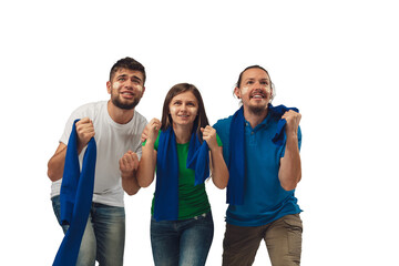 Hopeful. Three soccer fans woman and men cheering for favourite sport team with bright emotions isolated on white studio background. Looking excited, supporting. Concept of sport, fun, support.