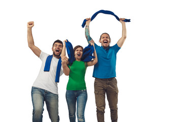 Fototapeta premium Victory. Three soccer fans woman and men cheering for favourite sport team with bright emotions isolated on white studio background. Looking excited, supporting. Concept of sport, fun, support.