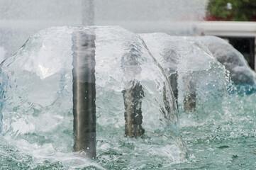 Naklejka na ściany i meble Falling water frozen in the fountain