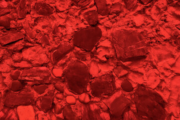 Abstract background of many large stones. The empty stone surface is red.
