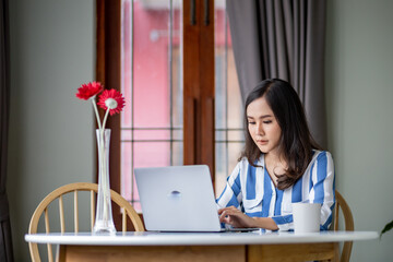 Asian woman made meeting online by using laptop