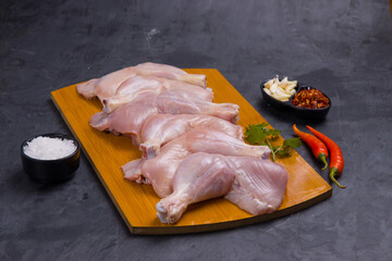 Raw whole chicken leg_grey board