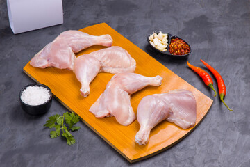 Raw whole chicken leg_grey board