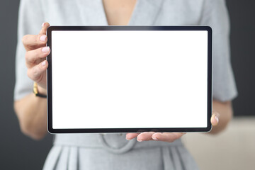Female hands hold tablet with white screen