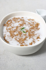 Jenang bubur abang or red brown sweet porridge with coconut milk. Cook and shared to neighbor for celebrate weton date birthday people from javanese culture.