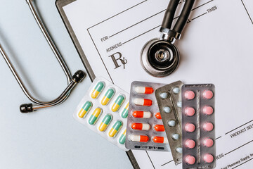 Medical concept flat lay with stethoscope, pills, notepad on the doctor desktop