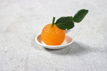 Orange jelly formed orange on a white plate.