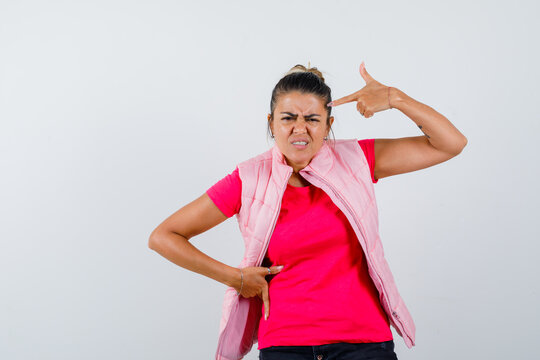  Lady Making Suicide Gesture In T-shirt, Vest And Looking Spiteful. Front View.