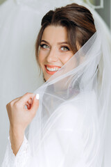 Portrait of a beautiful bride in the interior. Morning young girl in a robe.