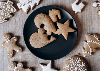 Homemade gingersnaps covered with icing on the wooden background