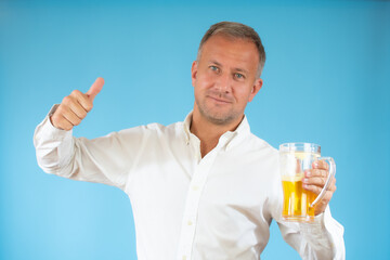man in a white shirt with a mug of beer on blue background