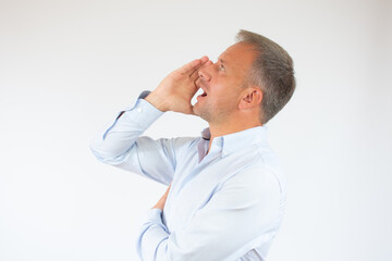 Fototapeta premium young man in shirt is holding hand near her open mouth isolated on white background with copy space for text