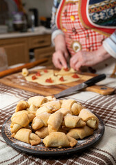 Woman preparing homemade rolls with jam  at home