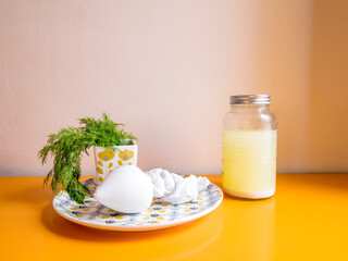 Cheese making homemade, process. Fabric with filtered milk and a jar with whey.
