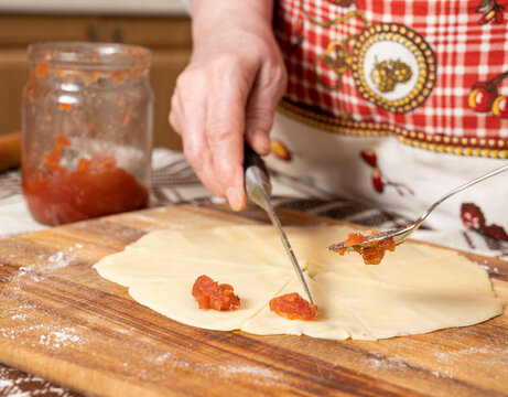 Woman Preparing Homemade Rolls With Jam  At Home