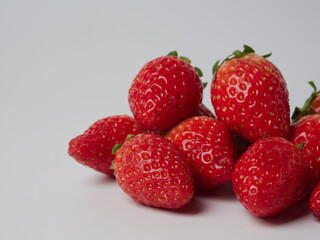 Fresh ripe delicious strawberries in a bowl on a white background