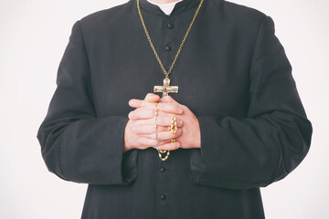 Catholic priest holds rosary