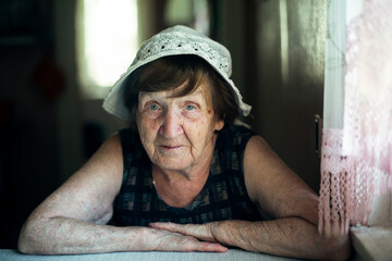 Portrait of an old russian woman in her house.