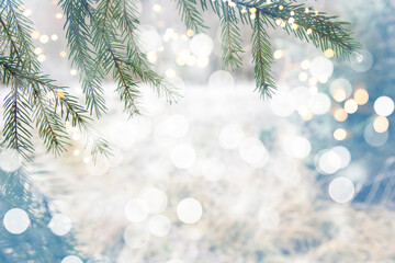 Abstract winter Christmas background with snow, fir branches and lights. Beautiful soft atmospheric natural background in pastel light colors. Xmas with tender bokeh