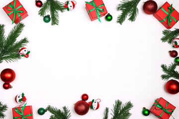 Christmas frame made of  decorations and fir branches on a white background.