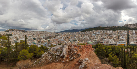 View of Athens from Strefi Hill during a morning with beautiful white clouds. The hill is located in Exarchia district, in downtown Athens, Greece, Europe