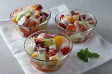 Fruits salad in glass bowl, with mayo sauce